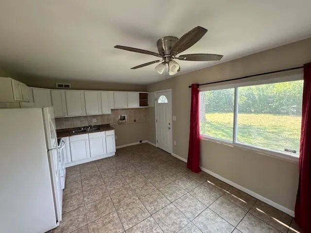 a view of a kitchen with a sink and a window