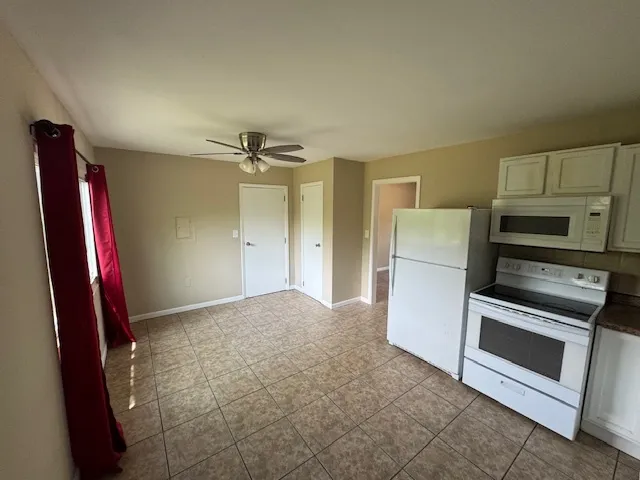a view of a kitchen with a sink and a refrigerator