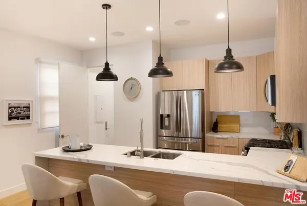 a dining table chairs and a chandelier