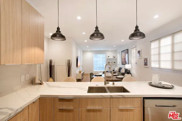 a kitchen with a sink and a chandelier