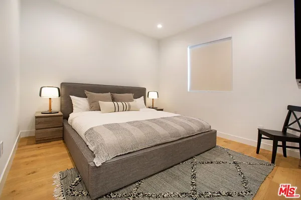 a bedroom with a bed and a table