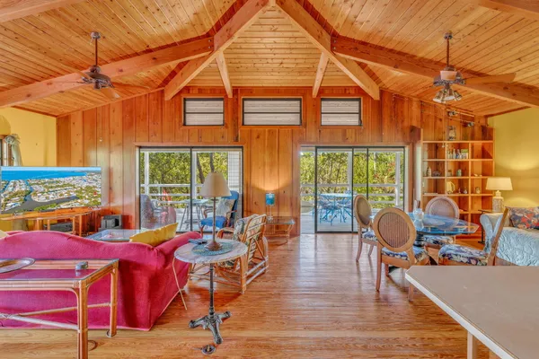 a living room with furniture and floor to ceiling windows