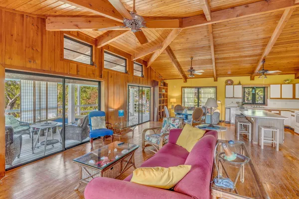 a living room filled with furniture and a large window