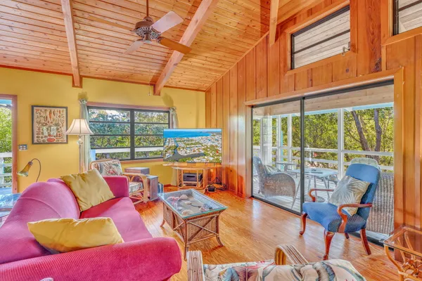 a dining room with furniture water view and wooden floor