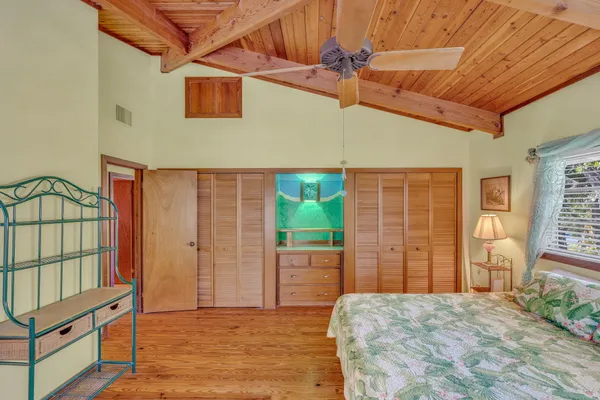 a bed sitting in a bedroom next to a window