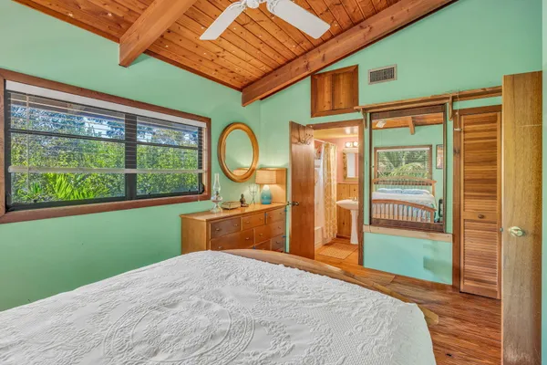 a bedroom with a large bed and a window
