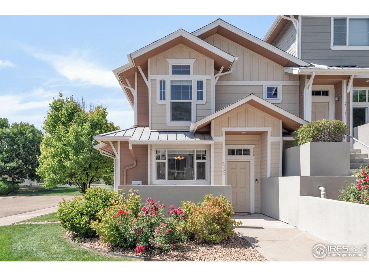 4232 Riley Drive Longmont, CO 80503 - Photo 1 of 35 a front view of a house with a yard and potted plants