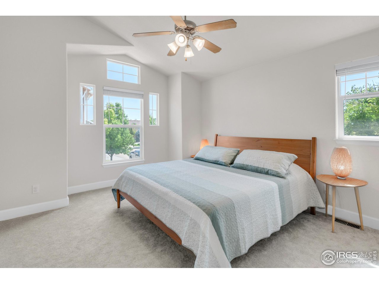 4232 Riley Drive Longmont, CO 80503 - Photo 20 of 35 a bedroom with a bed and a chandelier