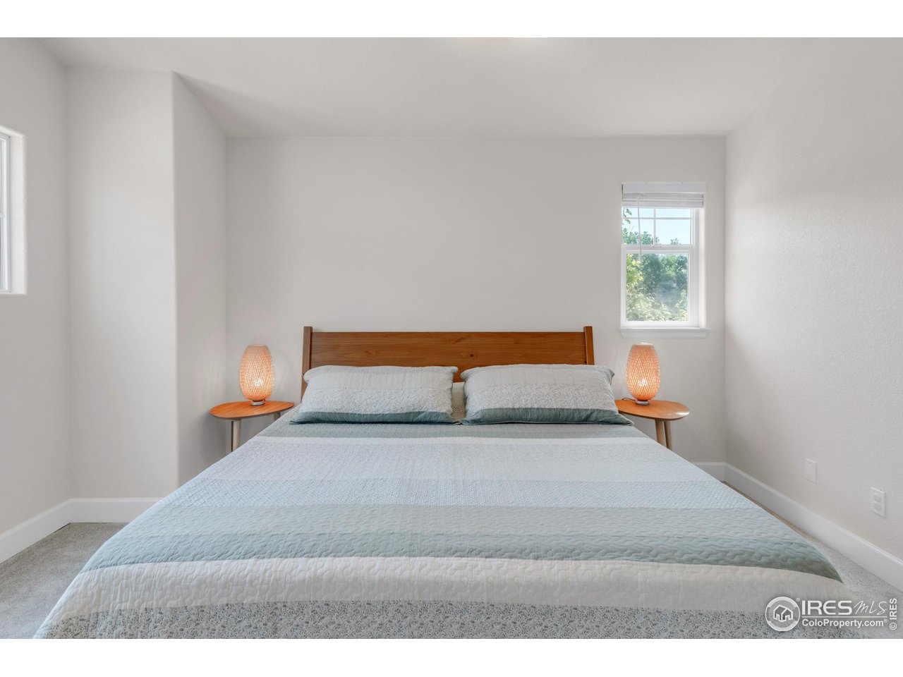 4232 Riley Drive Longmont, CO 80503 - Photo 22 of 35 a bedroom with a bed and a window