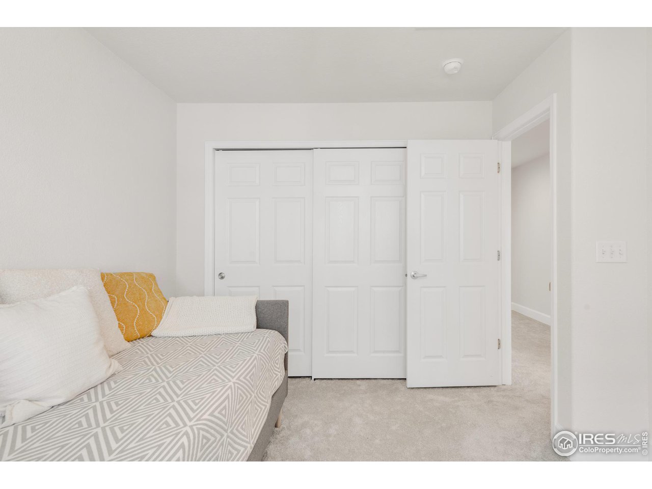 4232 Riley Drive Longmont, CO 80503 - Photo 27 of 35 a bedroom with a bed and a night stand