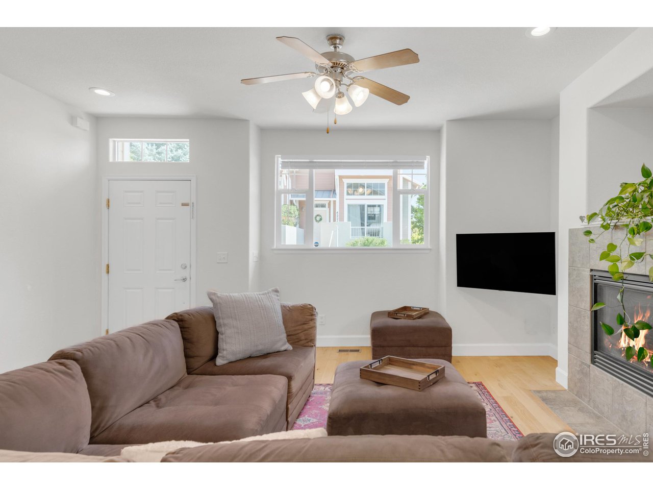 4232 Riley Drive Longmont, CO 80503 - Photo 6 of 35 a living room with furniture a chandelier and a flat screen tv