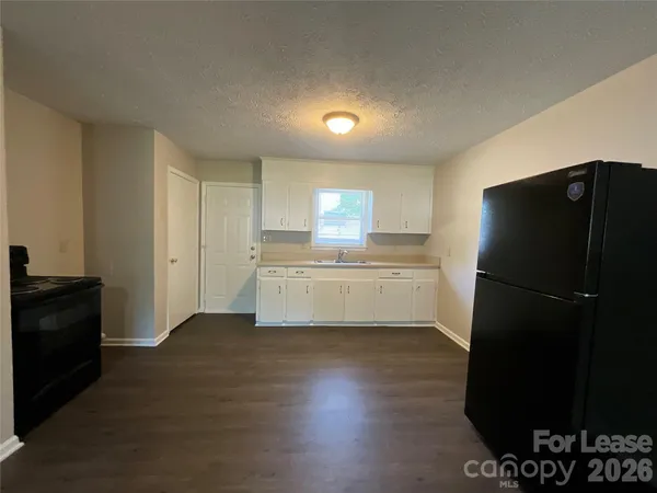a kitchen with a refrigerator and a stove