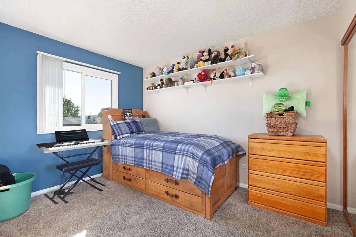 9433 Doheny Road Santee, CA 92071 - Photo 20 of 31 a bedroom with a bed and a window