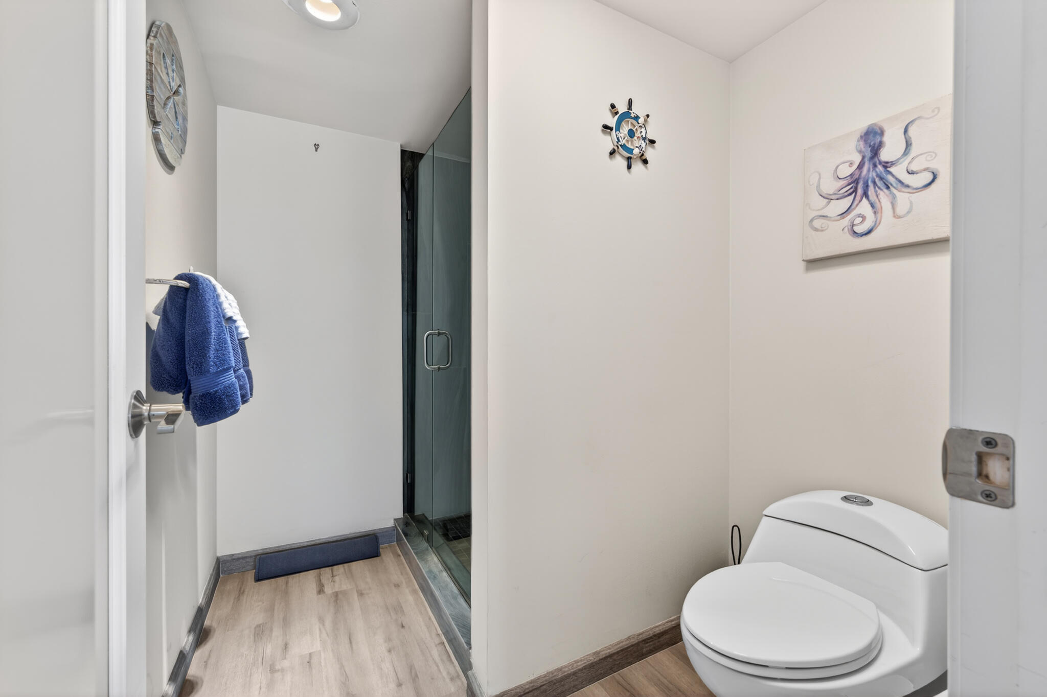 4250 North Hwy A1A, Unit 1007 Fort Pierce, FL 34949 - Photo 20 of 24 a white toilet sitting next to a shower curtain