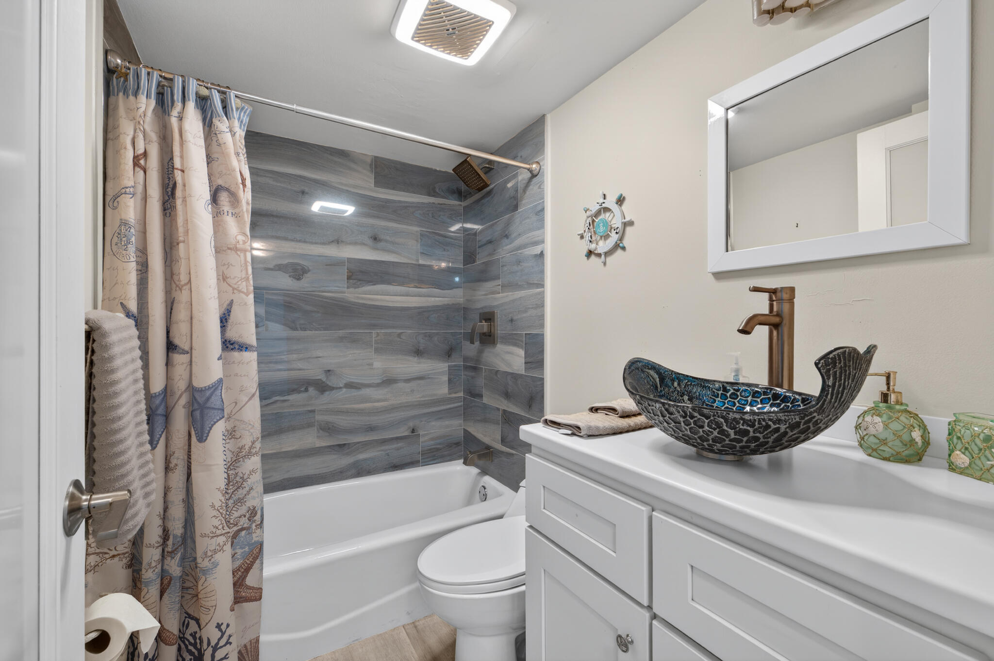 4250 North Hwy A1A, Unit 1007 Fort Pierce, FL 34949 - Photo 24 of 24 a bathroom with a granite countertop sink a toilet and a bathtub