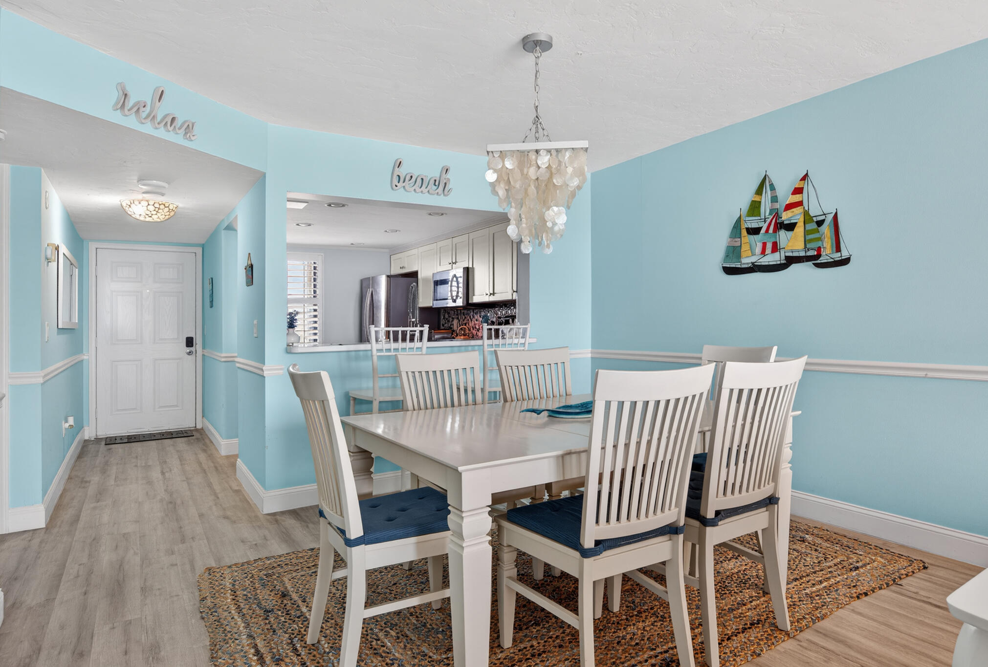 4250 North Hwy A1A, Unit 1007 Fort Pierce, FL 34949 - Photo 7 of 24 a view of a dining room with furniture a chandelier and wooden floor