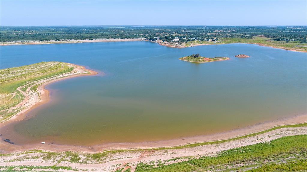 659 Rocky Point Road Blackwell, TX 79506 - Photo 3 of 40 Expansive lake with a broad shoreline, featuring distant green islands and a tree-lined horizon