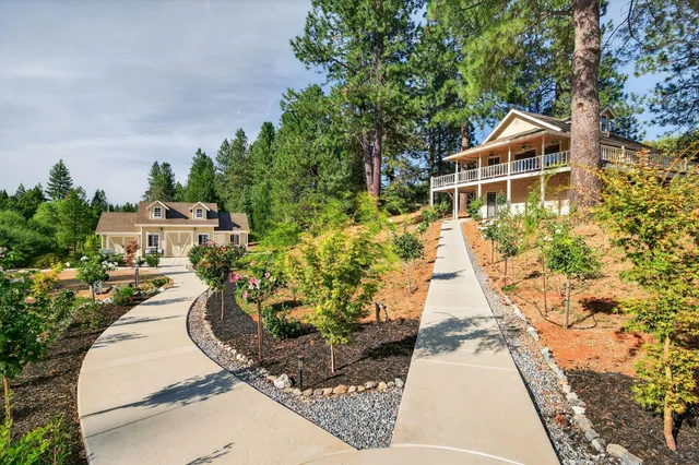 a front view of a house with a yard and a garden