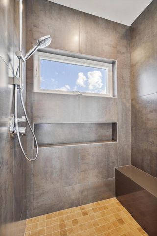 a bathroom with a glass shower door
