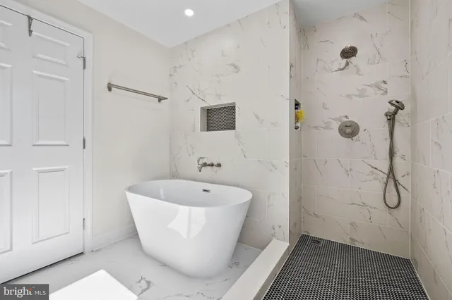 a white bath tub sitting next to a white sink