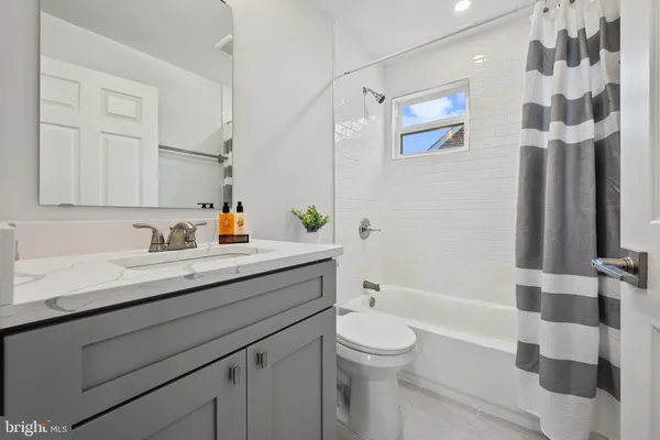 a bath room with a sink a toilet and a shower