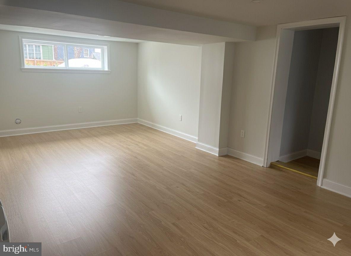 708 Hankin Street Silver Spring, MD 20910 - Photo 26 of 37 an empty room with wooden floor and windows
