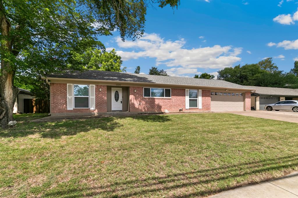 909 North Dove Road Grapevine, TX 76051 - Photo 2 of 30 Brick facade home featuring a prominent front lawn, a white main entry door, and white window shutters