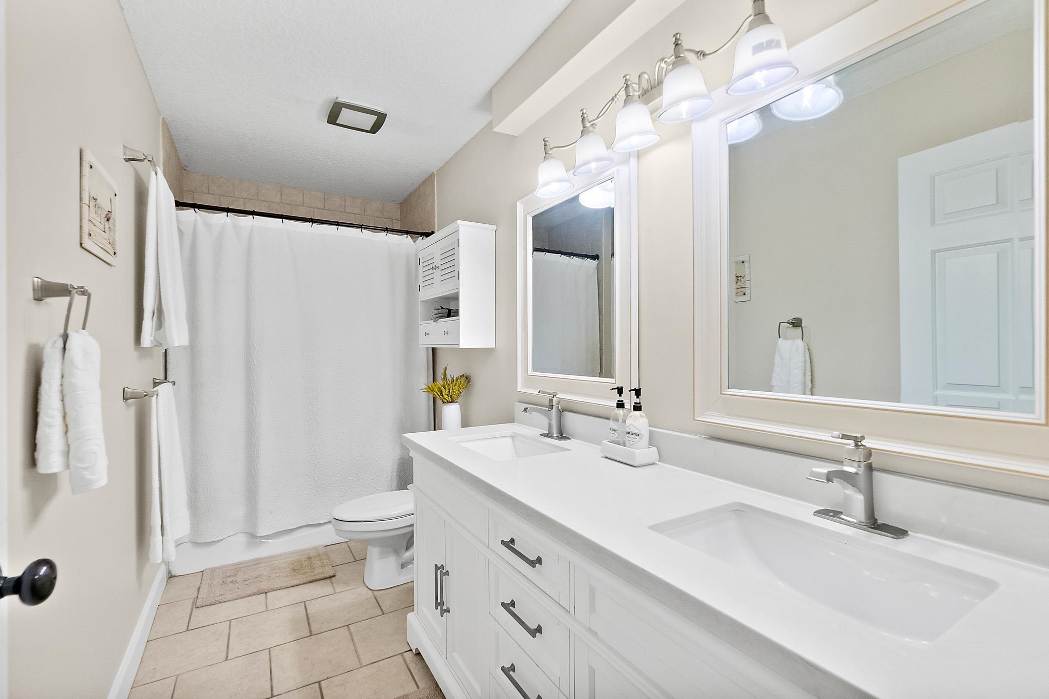 3253 Turtle Creek Road St. Augustine, FL 32086 - Photo 25 of 40 a bathroom with a double vanity sink mirror and toilet