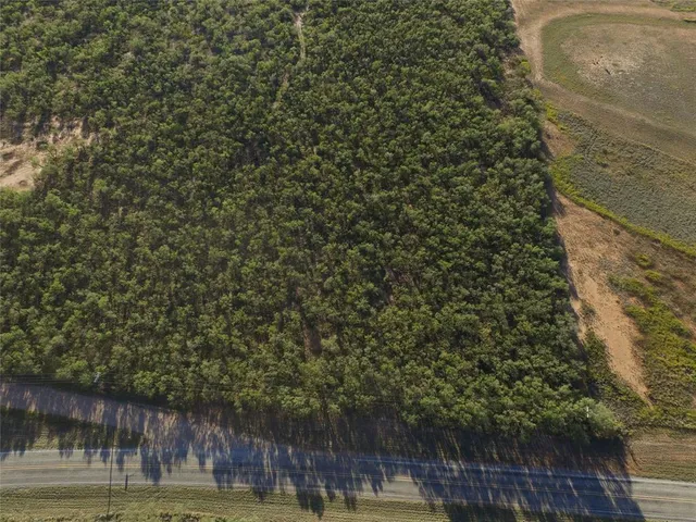 a view of a yard with wooden fence