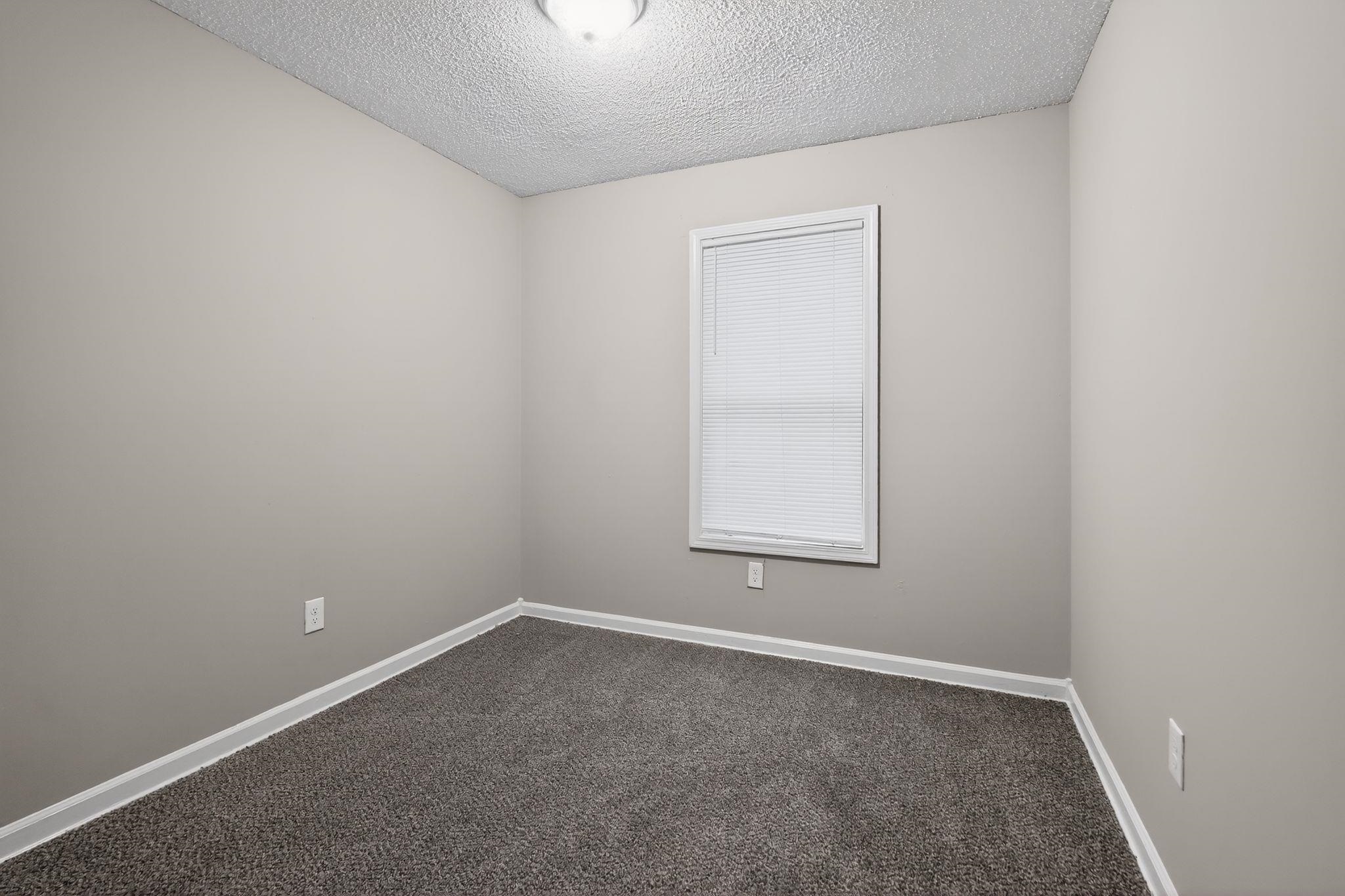 4725 Lofts Road Memphis, TN 38118 - Photo 13 of 32 Unfurnished room with a textured ceiling and dark carpet