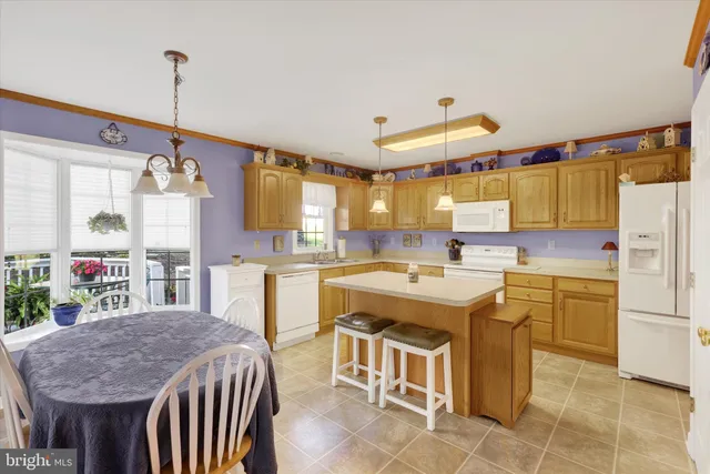 a kitchen that has a lot of cabinets in it and appliances