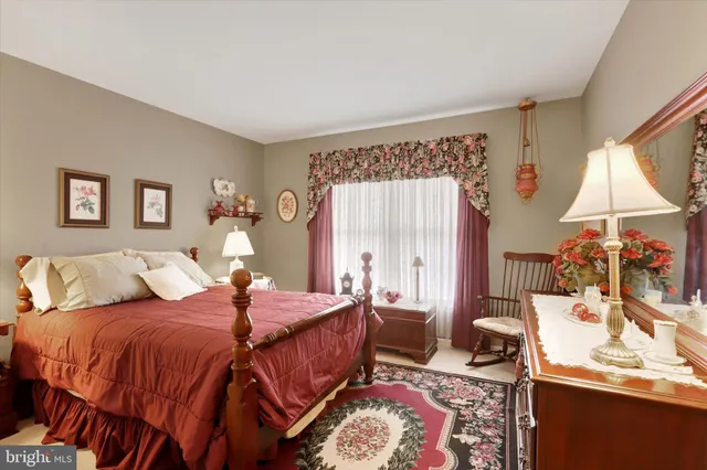 a bed room with a bed and a chair