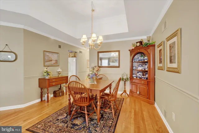 a view of a dining room with furniture and chandelier
