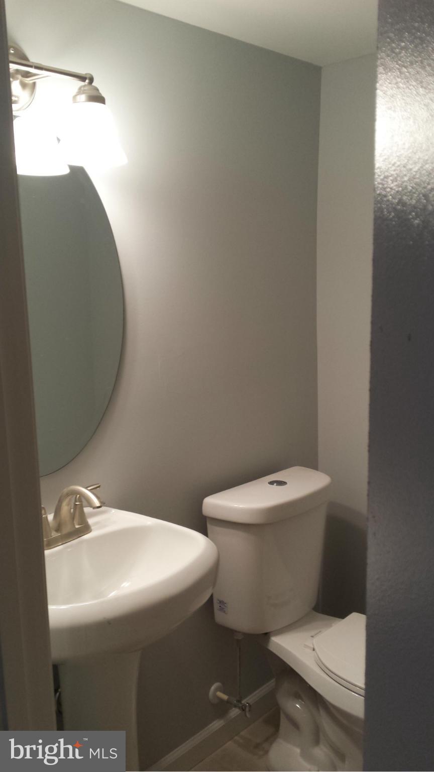 1111 Wicklow Road Baltimore, MD 21229 - Photo 14 of 15 a white toilet sitting next to a bathroom sink