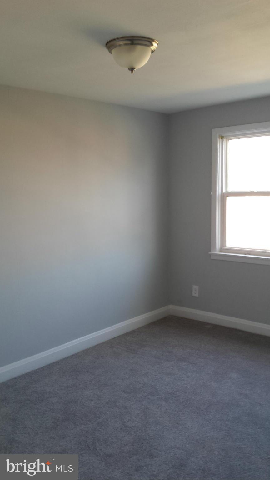 1111 Wicklow Road Baltimore, MD 21229 - Photo 8 of 15 an empty room with a window