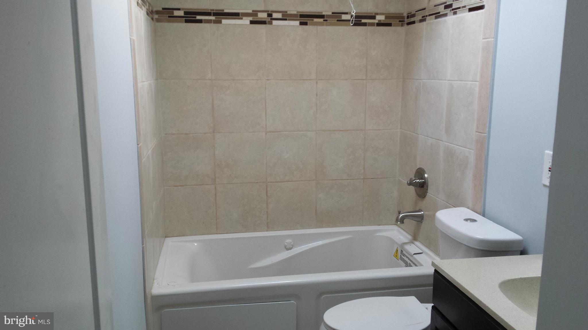 1111 Wicklow Road Baltimore, MD 21229 - Photo 10 of 15 a bathroom with a bathtub and a toilet