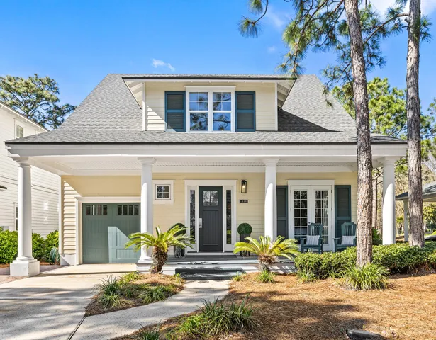 a front view of a house with outdoor seating
