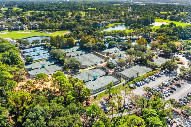 a living room with furniture and three windows