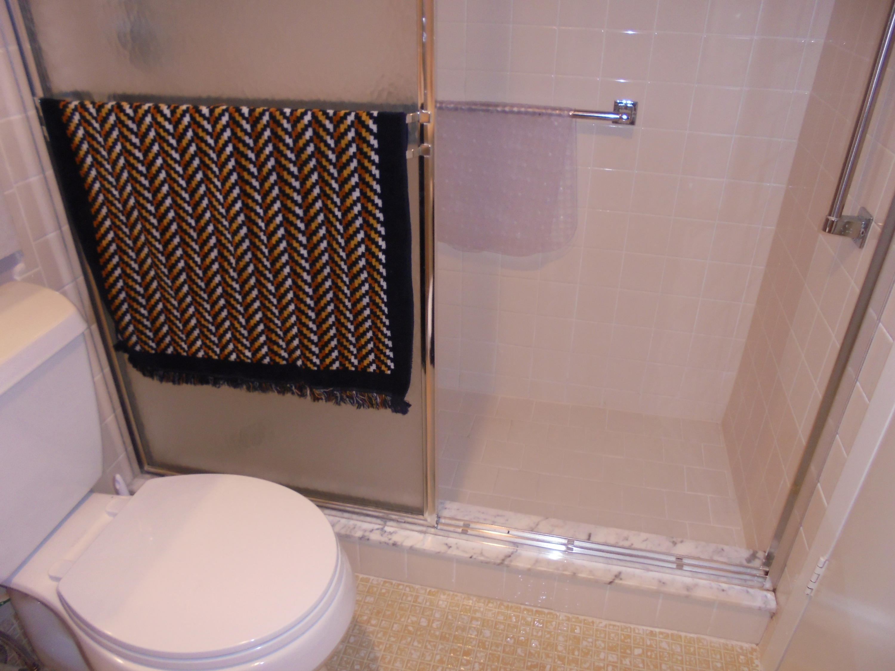 3 Dorset A Boca Raton, FL 33434 - Photo 15 of 18 a bathroom with a toilet and a shower