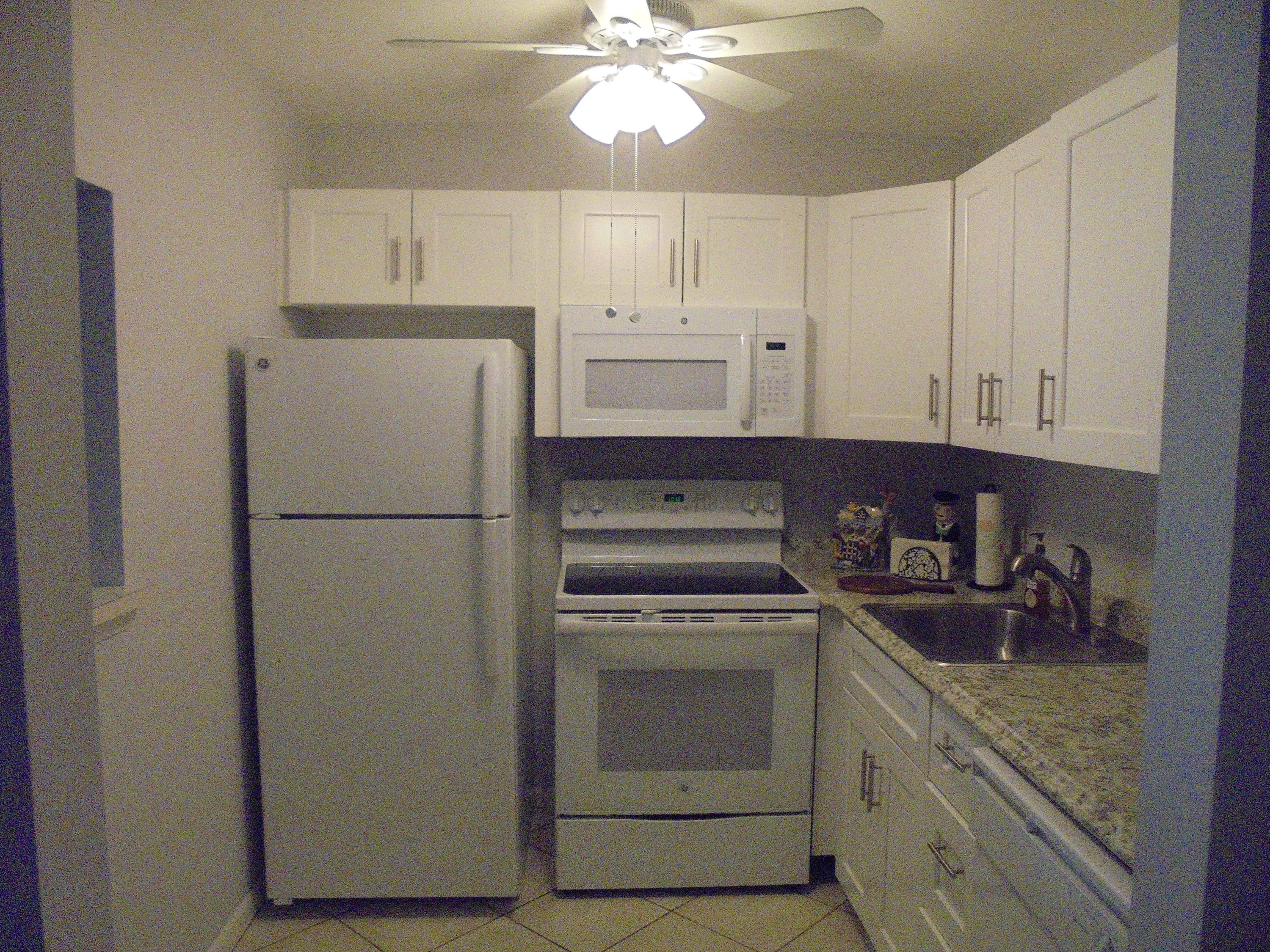 3 Dorset A Boca Raton, FL 33434 - Photo 7 of 18 a kitchen with a refrigerator sink and cabinets