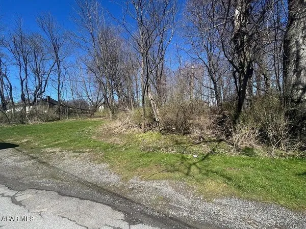 a backyard of apartments with large trees