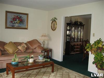 0 Rr Kunkletown, PA 18058 - Photo 5 of 12 Formal living room leading to formal dining room. Note the wall to wall carpeting and neutral colors.