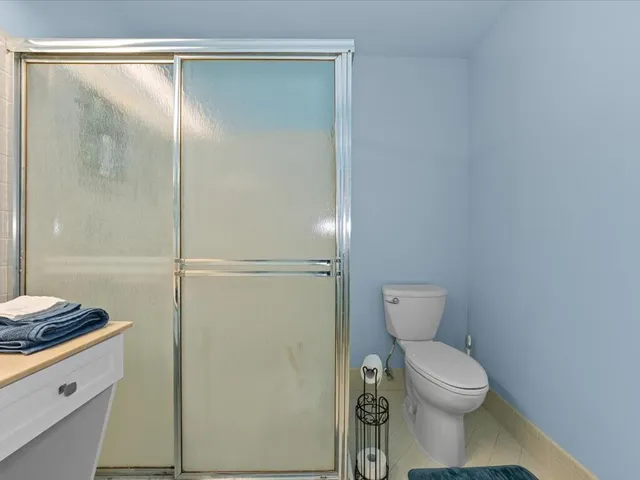 a bathroom with a toilet and a shower
