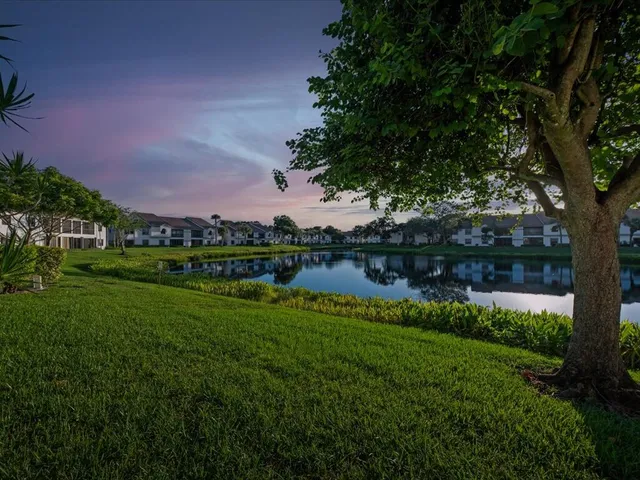 a view of a lake with a house in the background