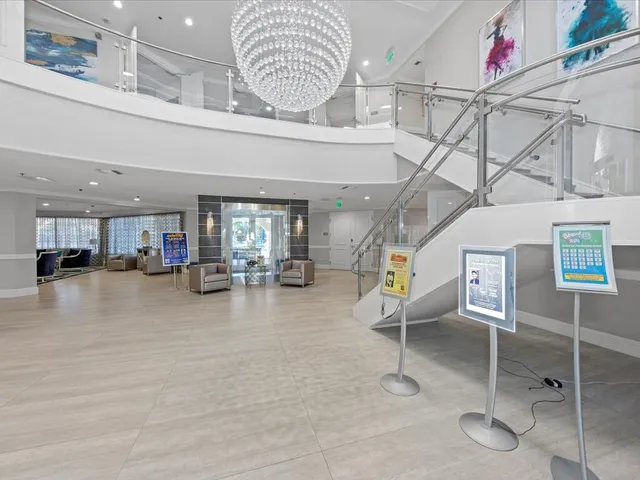 a living room with furniture a rug and a large window