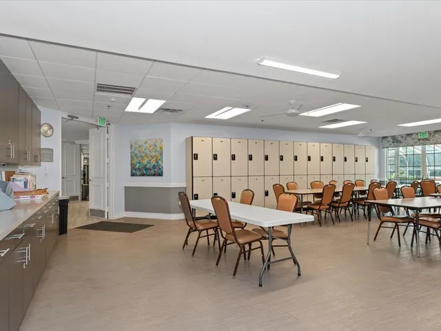 a room with lots of tables and chairs