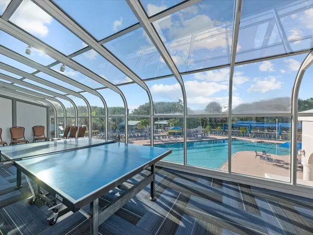a view of a house with a large window and plants