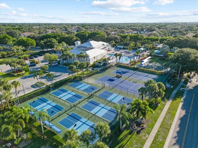 an aerial view of residential houses with outdoor space and swimming pool