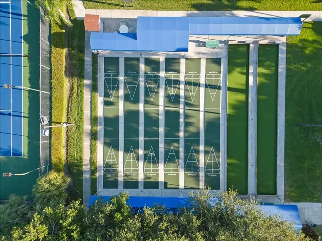 an aerial view of a house with a garden and outdoor seating