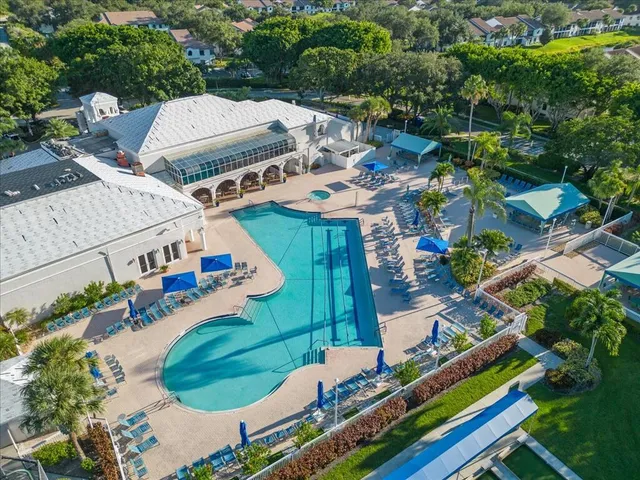 an aerial view of residential houses with outdoor space and trees